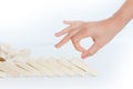 Human hand starting a domino effect concept Royalty Free Stock Photo