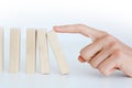 Human hand starting a domino effect concept Royalty Free Stock Photo