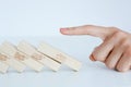 Human hand starting a domino effect concept Royalty Free Stock Photo