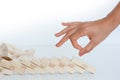 Human hand starting a domino effect concept