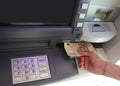 taking euro banknotes from an ATM after typing the code Royalty Free Stock Photo
