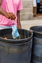 human hand throwing face mask into trash