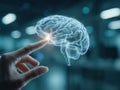 Close-up of a human hand interacting with a glowing holographic brain interface in a blurred high-tech office environment with Royalty Free Stock Photo