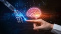 Human hand touching a holographic brain interfacing with a robotic arm, a metaphor for AI and human collaboration Royalty Free Stock Photo