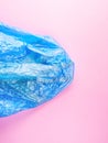 Human hand trapped in plastic bag on pink