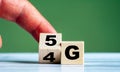 Hand turn wooden block and change technology word 4G to 5G. Network future. High speed of mobile internet