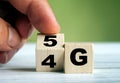 Hand turn wooden block and change technology word 4G to 5G. Network future. High speed of mobile internet