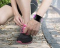 Human hand tying shoelaces wearing smartwatch with bright pink w Royalty Free Stock Photo