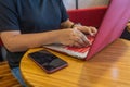 Human hand typing on laptop with red colored keyboard case Royalty Free Stock Photo