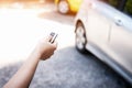 The human hand is using car remote control key for open the car, Royalty Free Stock Photo