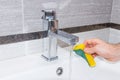 Human Hand wash sink in the bathroom. Royalty Free Stock Photo