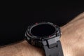 Human hand wearing smart watch on black background. Wearable gadget concept Royalty Free Stock Photo