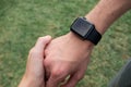 Human hand wearing smart watch. Wearable gadget concept. A couple holding hands. Closeup Royalty Free Stock Photo