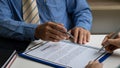 Human hand working with documents at close-up table signature document Emphasis on female hand pen, sign official documents, conta Royalty Free Stock Photo