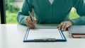 Human hand working with documents at close-up table signature document Emphasis on female hand pen, sign official documents, conta Royalty Free Stock Photo