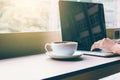 Human hand working on keyboard laptop with coffee in morning. Royalty Free Stock Photo