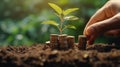 Human hand and young green sprout growing on coin stacks over green blurred background. Business finance strategy, money Royalty Free Stock Photo