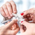 Human Hands Assembling Puzzle Pieces