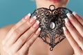 Human hands with beautiful manicure hold a openwork heart