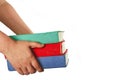 Human hands carrying the pile of books at white isolated background. Royalty Free Stock Photo