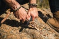 Human hands carving a wooden stick with knife in nature Royalty Free Stock Photo