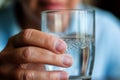 Human hands close up holding glass mineral water adult man drinking fresh clear health pure refreshing beverage