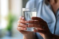 Human hands close up holding glass mineral water woman drinking fresh clear health pure refreshing beverage wellbeing