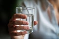 Human hands close up holding glass mineral water young man woman drinking fresh clear health pure refreshing beverage Royalty Free Stock Photo