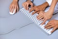Human hands on computer keyboard with one hand using computer mouse Royalty Free Stock Photo