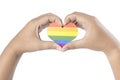 Human hands with heart shape showing heart with a rainbow flag as a symbol of LGBT Royalty Free Stock Photo