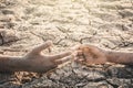 Human hands helping on cracked dry ground Royalty Free Stock Photo