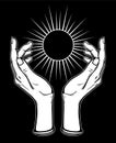 Human hands hold a symbol of the shining sun.