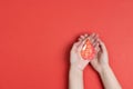 Human hands holding blood drop symbol on red background with copy space. Blood donation Royalty Free Stock Photo