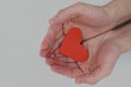 Human hands holding a red heart. Kindness, love, compassion and charity concepts Royalty Free Stock Photo