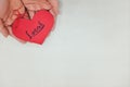 Human hands holding a red heart tag with handwritten word local. Support, promote, buy, shop and love local business concept.