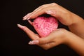 Human hands with manicure hold pink heart Royalty Free Stock Photo