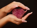 Human hands with manicure hold pink heart Royalty Free Stock Photo