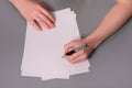 Human hands with pencil writing on paper and erase rubber on wooden table background Royalty Free Stock Photo