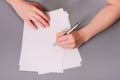 Human hands with pencil writing on paper and erase rubber on wooden table background Royalty Free Stock Photo