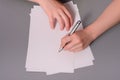 Human hands with pencil writing on paper and erase rubber on wooden table background Royalty Free Stock Photo