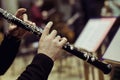 Human hands playing the oboe