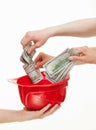 Human hands putting money in the hard hat Royalty Free Stock Photo