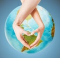 Human hands showing heart shape over earth globe Royalty Free Stock Photo