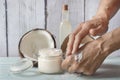 Human hands smearing homemade coconut and roses cream Royalty Free Stock Photo