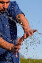 Human hands in splashes of water. Vertical photography.