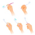 Human hands with toothbrushes and toothpaste on the brush.