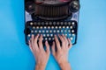 Human hands typing on vintage type writer machine - top view. Royalty Free Stock Photo