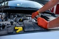 Human hands with wrenches in protective gloves upon car engine