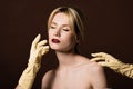 human hands in yellow gloves touching seductive naked blonde girl Royalty Free Stock Photo