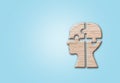 Human head silhouette with a jigsaw piece cut out on the blue background, mental health concept Royalty Free Stock Photo